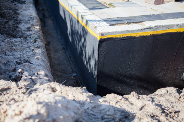Professional Waterproofing technician working in Shepherd, MI